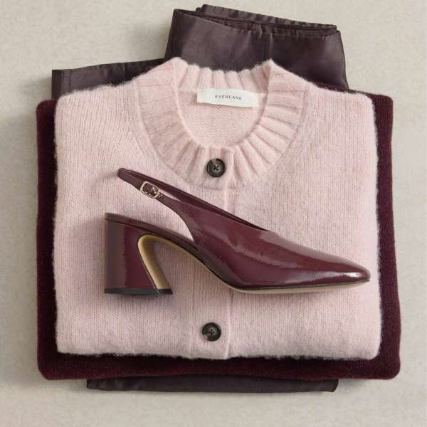 a stack of clothing and shoe in red hue