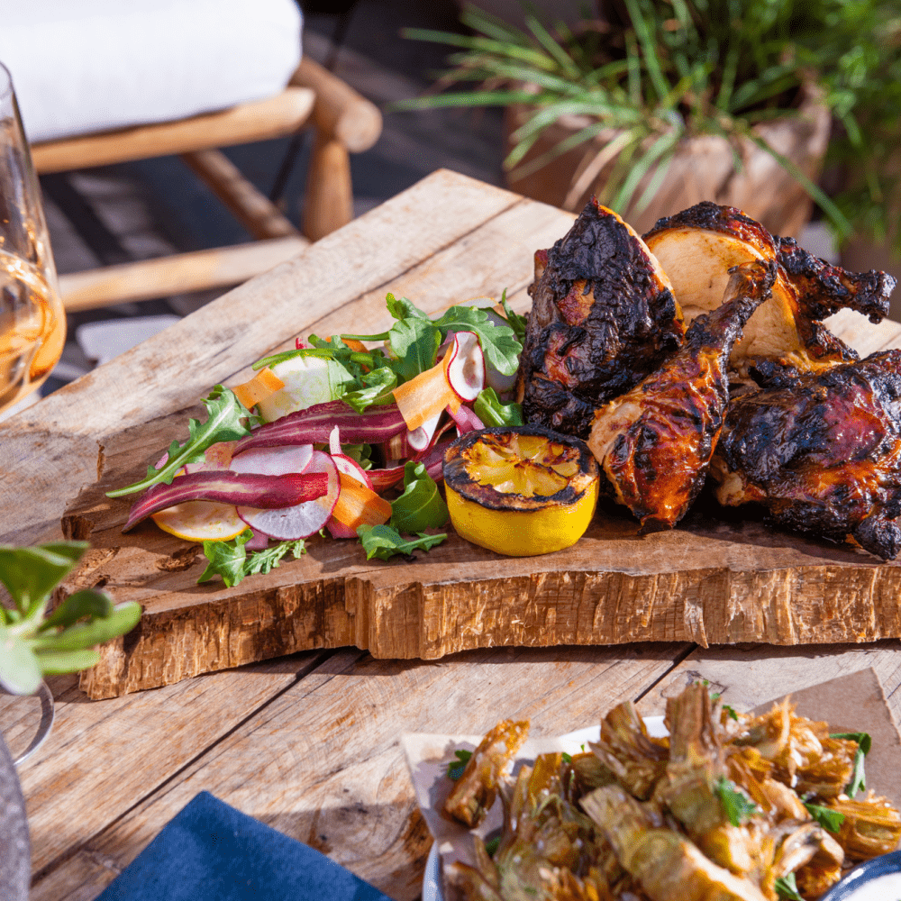 Chili marinated half chicken on a wood slab