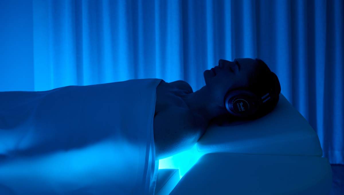 A person on spa bed with blue lighting in Melbourne Bamford Spa