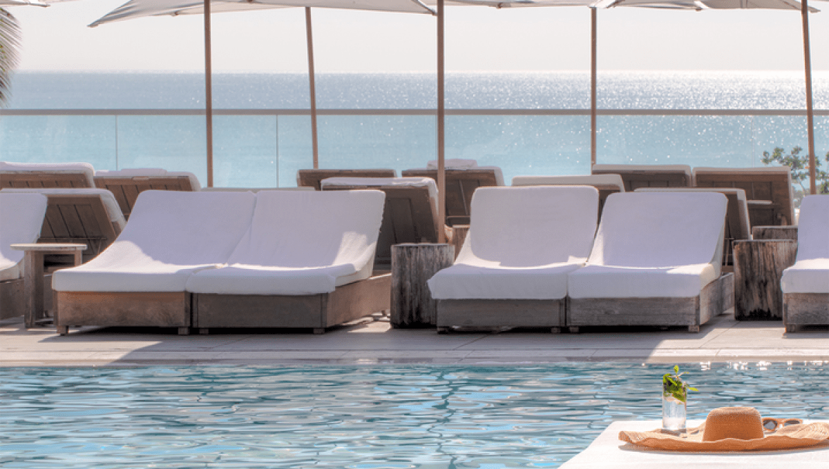 Rows of lounge chairs lined up at a pool deck