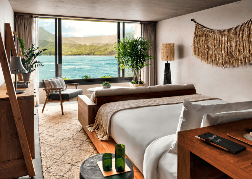A bedroom with a view of the ocean just outside