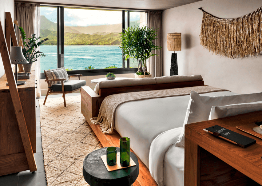 A bedroom with a view of the ocean just outside