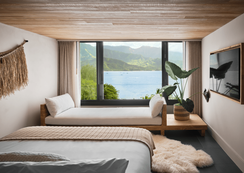 A hotel room with a view of the ocean just outside