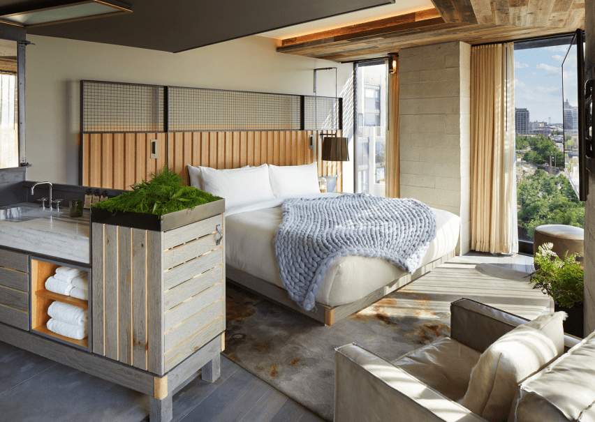 Sunny bedroom with a quilt laid over the bed
