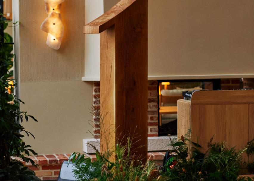 A wooden "1" sign with greenery decorated around it