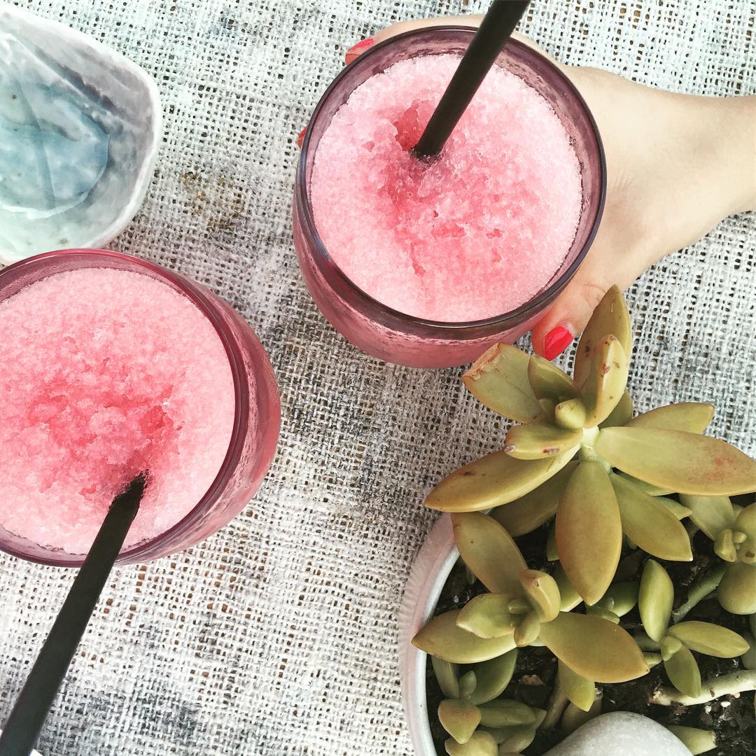 Two pink frosty drinks in glasses