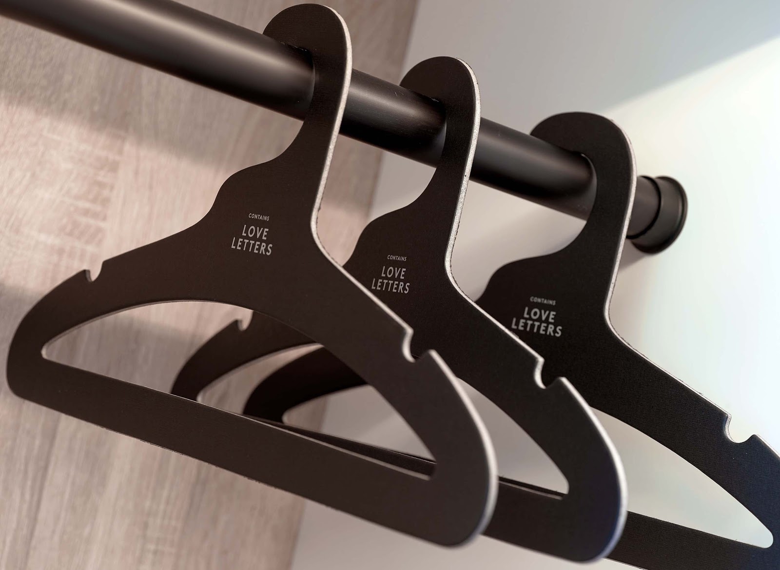 Three clothes hangers made from recycled paper products