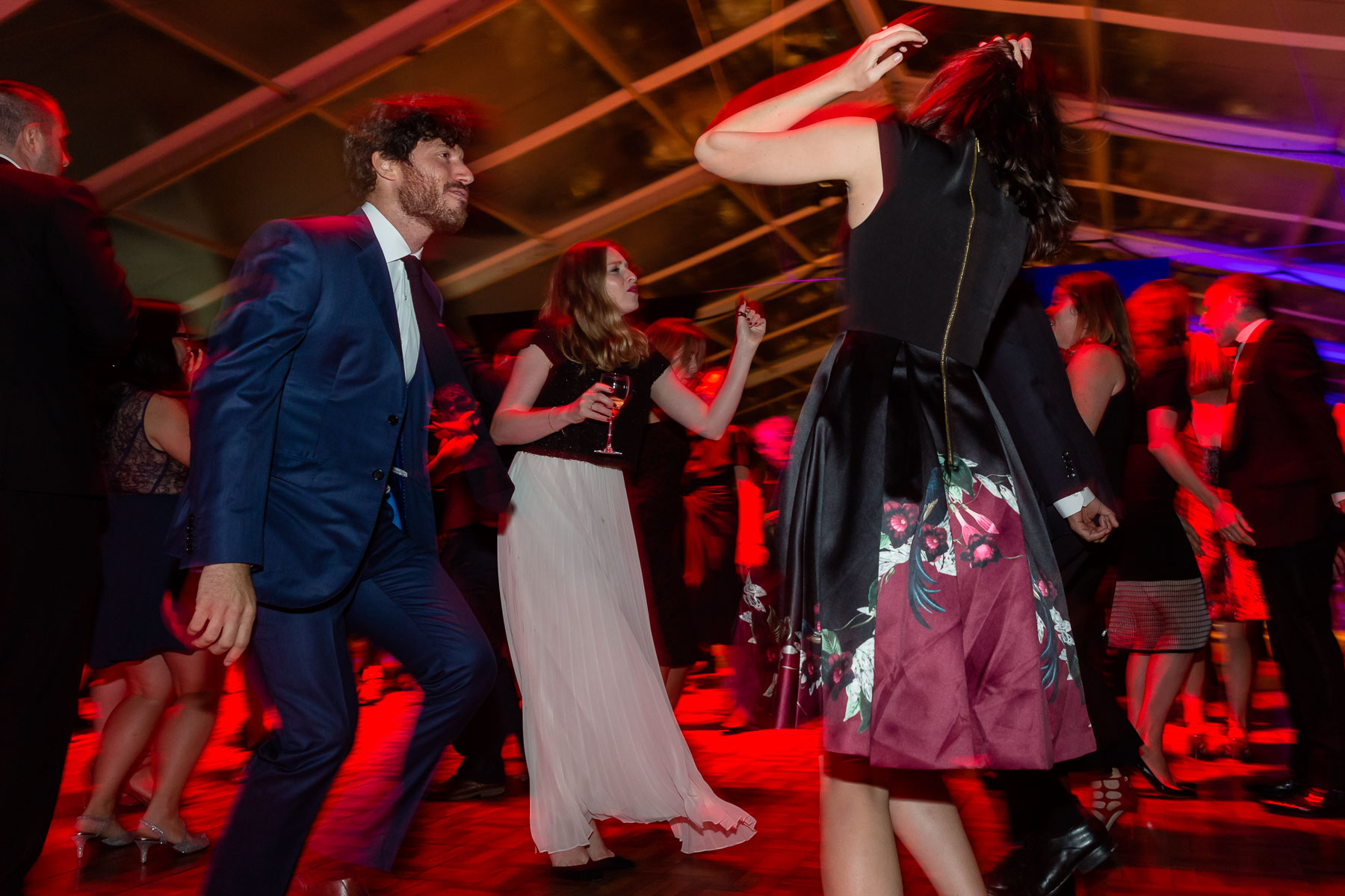 People in formal attire dancing at a black tie ball