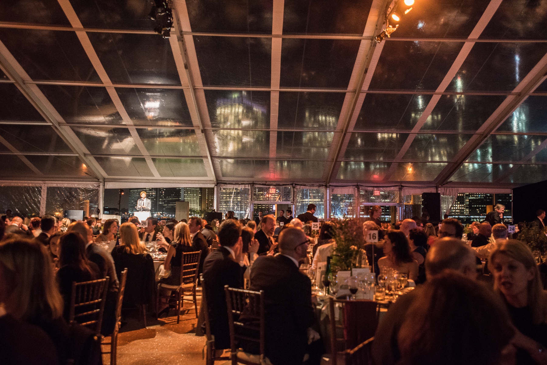 People seated at a formal dinner with a speaker