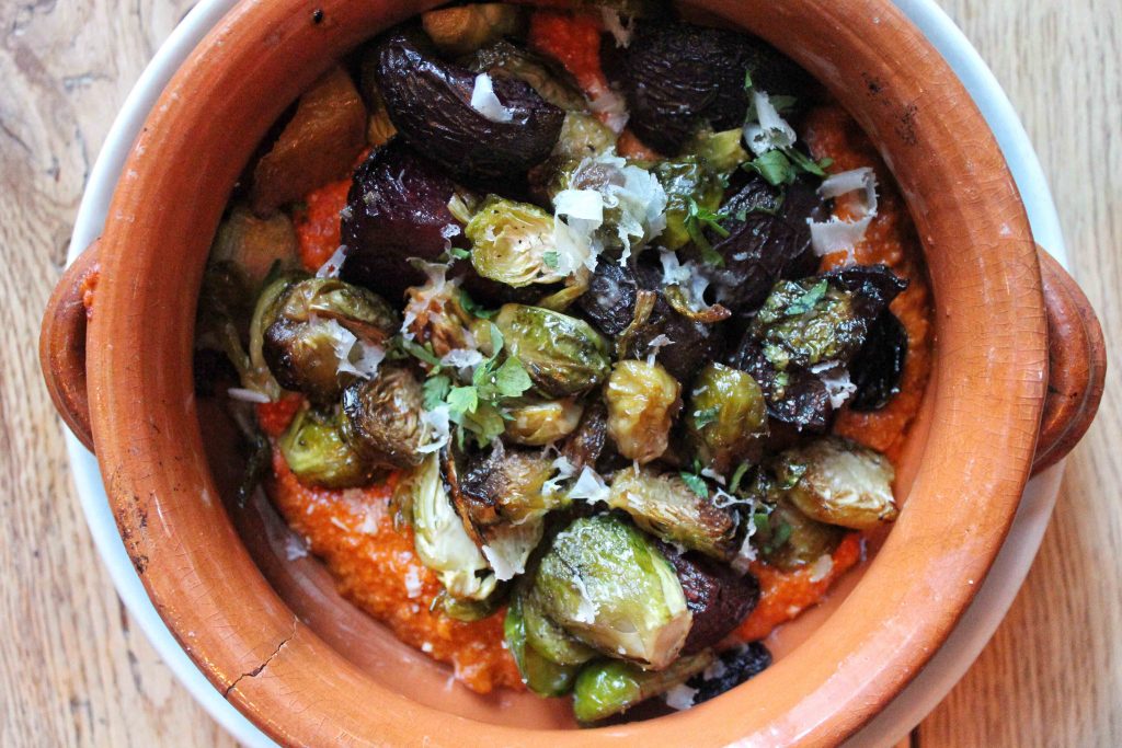 A dish of roasted squash and brussel sprouts