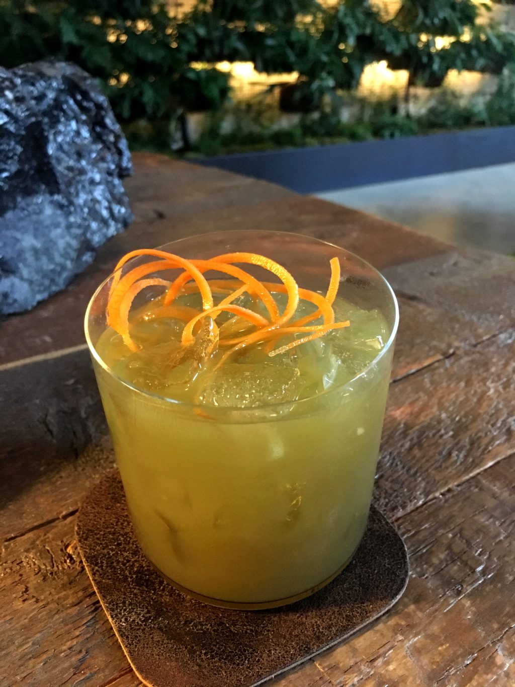 A cocktail garnished with orange peel spirals