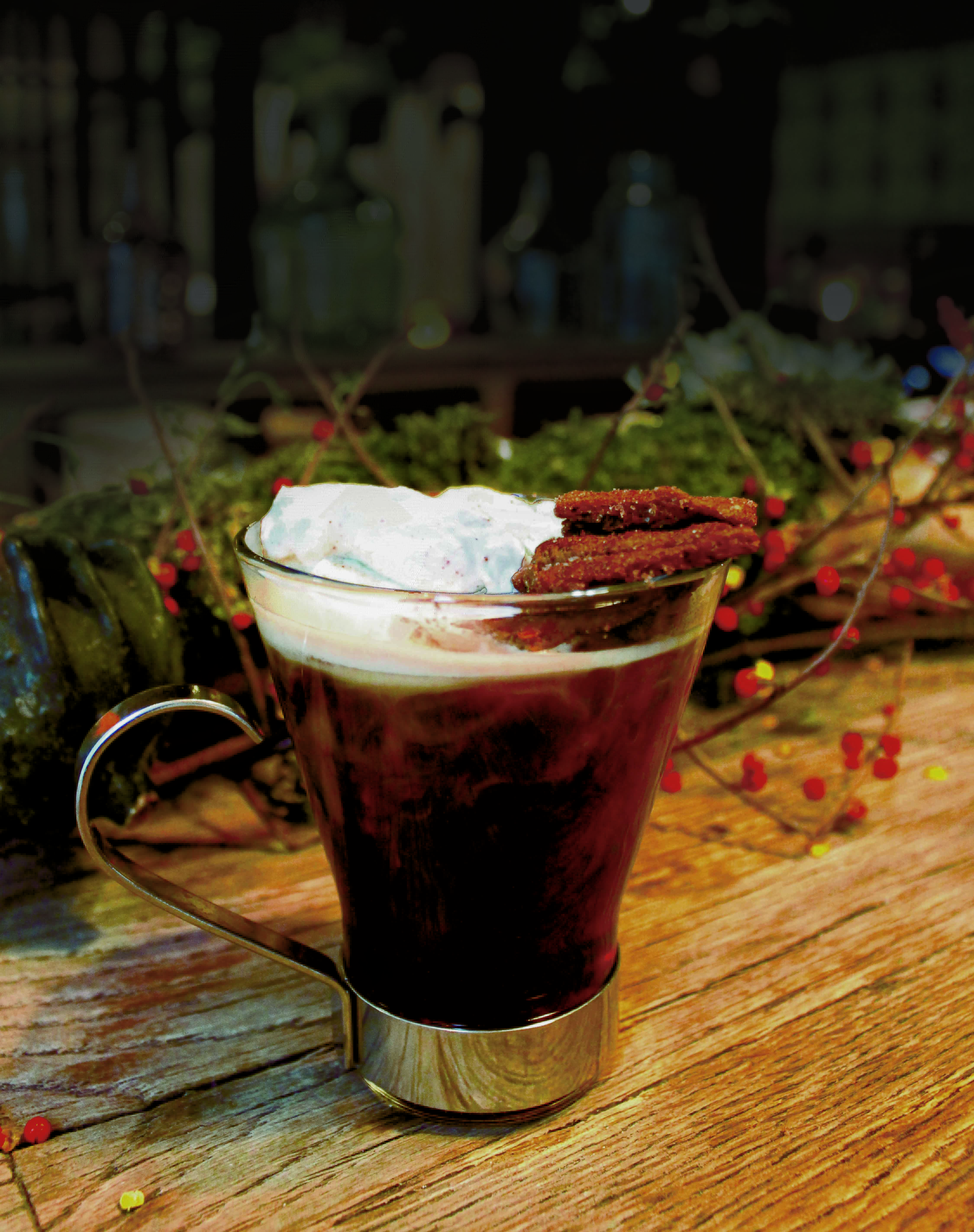 A cinnamon spiced tea with whipped cream in a clear mug