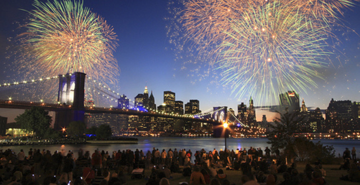 Fireworks exploding over the Brooklyn Bridge and Manhattan skyline