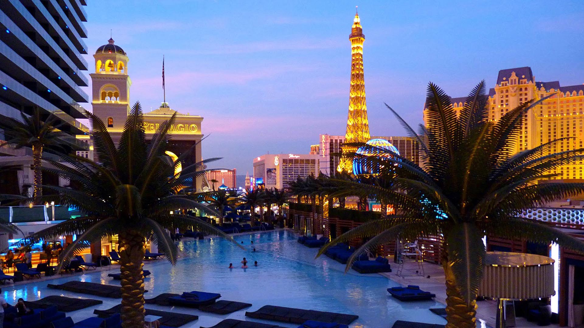 A pool and the Las Vegas skyline at night