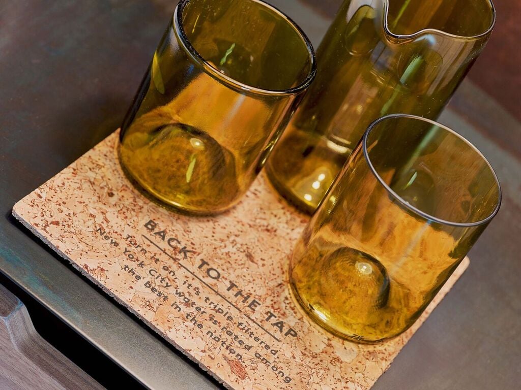Green drinking glasses on a cork coaster