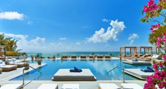 South Beach pool surrounded by cabanas and day loungers