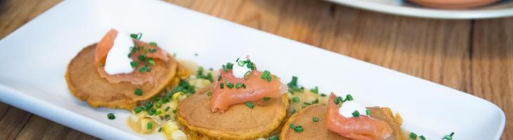 Corn and whole wheat pancakes topped with salmon
