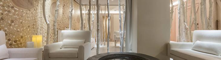 spa interior with birch tree accents and white leather couches
