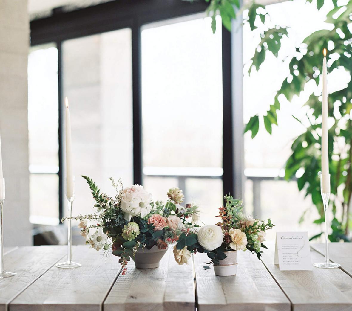 white and pink flower arrangements on a wooden table