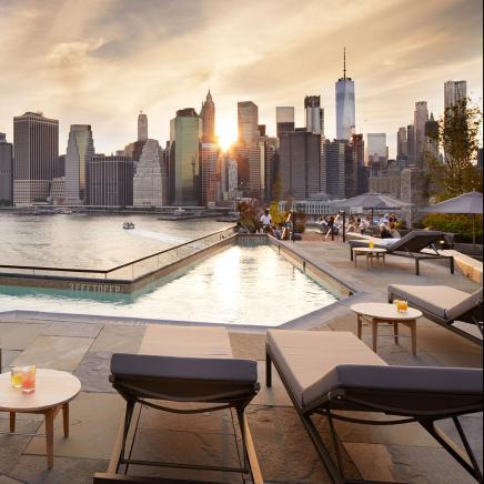 View of skyline next to pool at rooftop brooklyn bridge