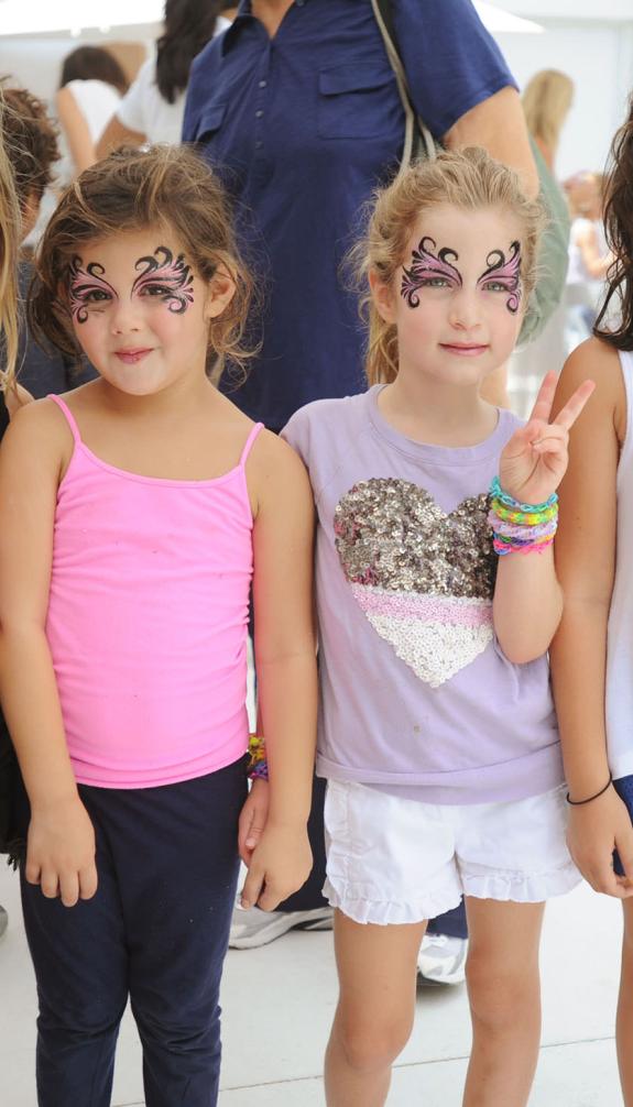 Little girls with butterfly face paint smile for the camera