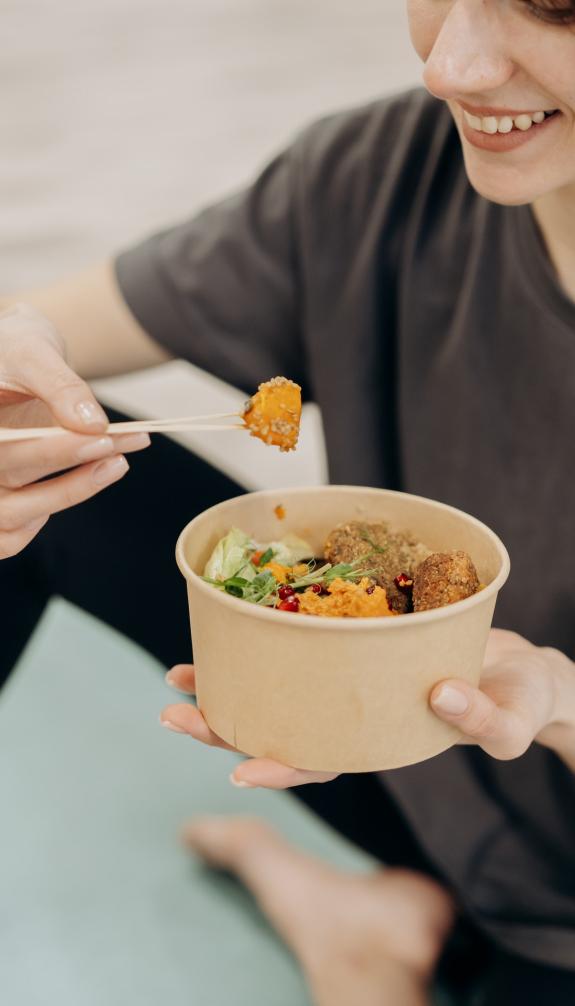 Woman eating healthy food from a bowl