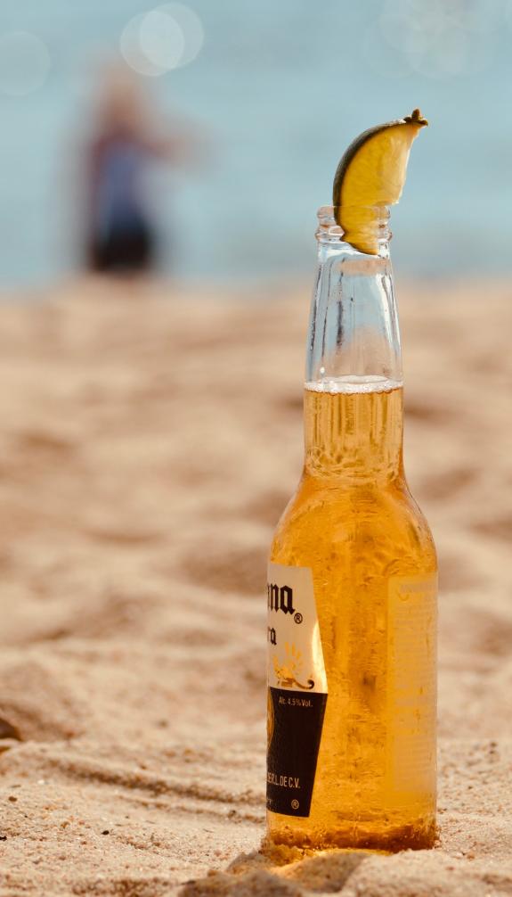 Bottle of corona beer in the sand