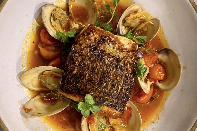 Striped Bass with Spicy Tomato Broth, Toasted Fregola & Local Clams